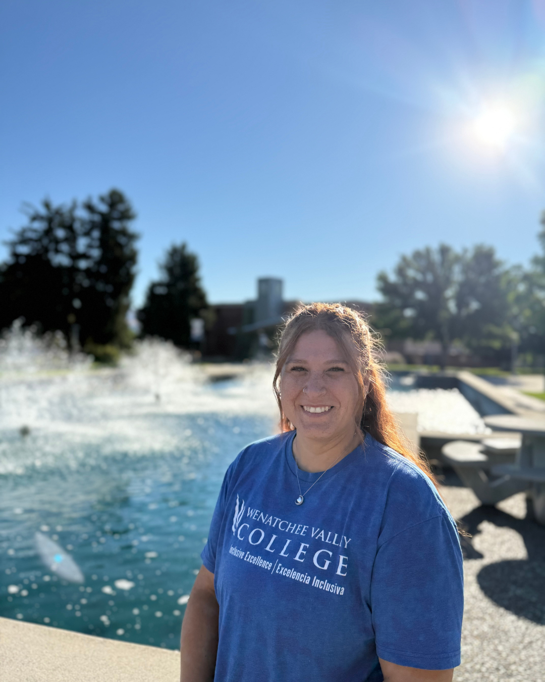 WVC alum Iris Rodriguez stands in front of the campus fountain.