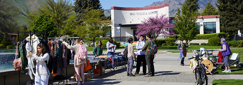 Earth Day event with students near the WVC fountain looking at used clothing availabe.