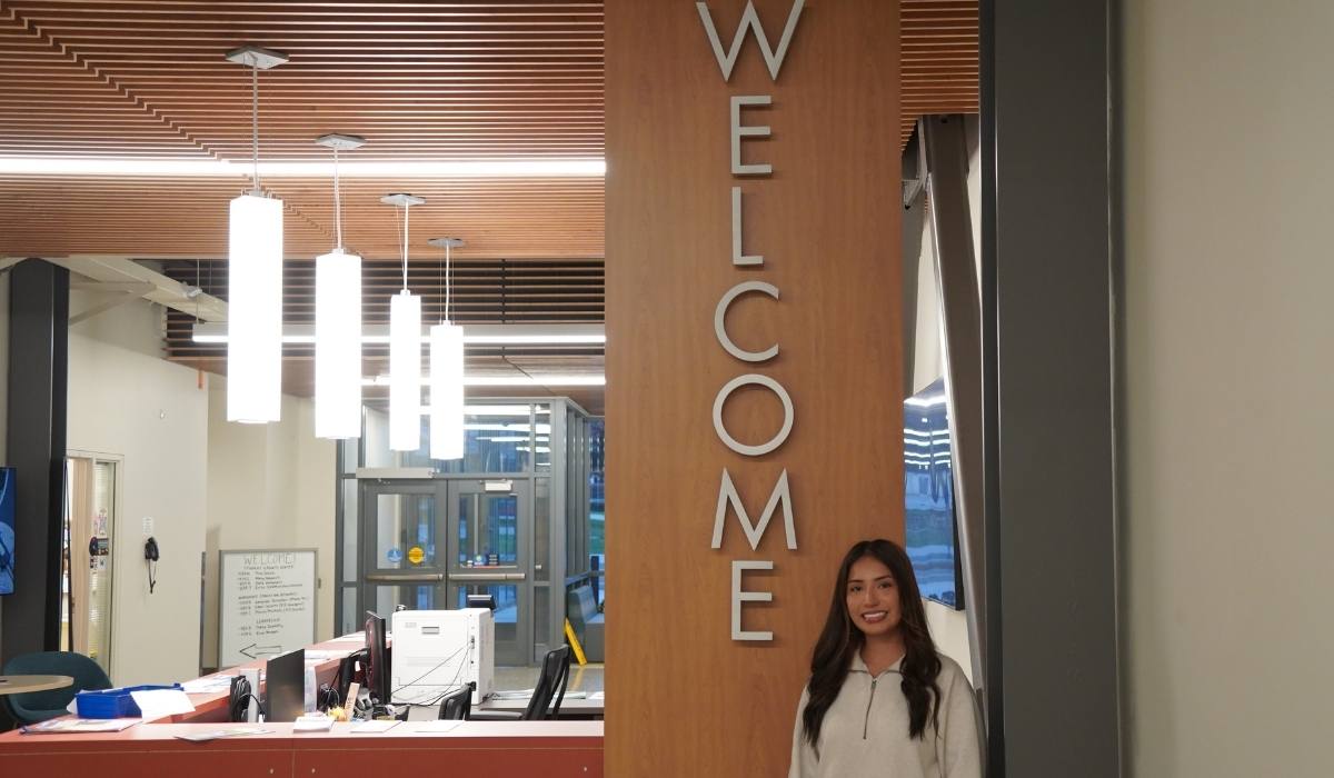 WVC Student Benefits Navigator in front of the welcome desk in Mish ee twie