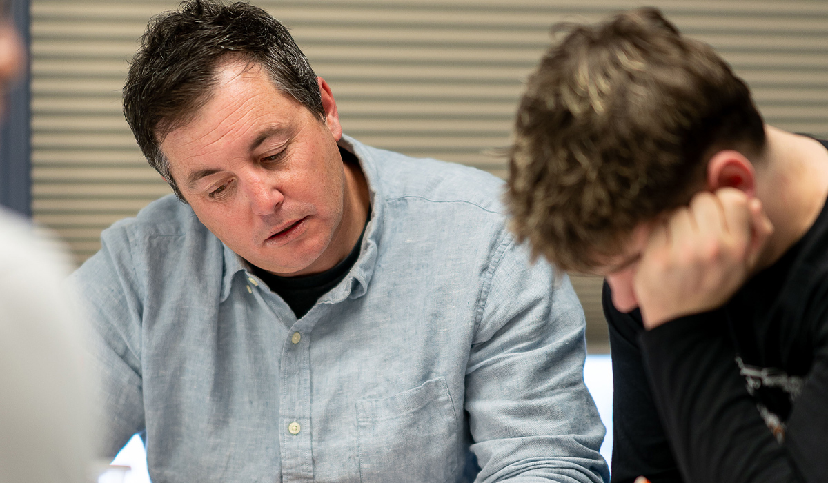 A math instructor helps a student.