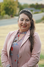 Portrait of Maria Mendoza-Sanchez standing outside.