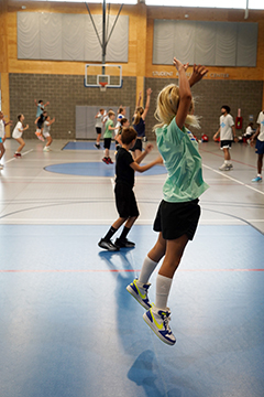Nike Basketball Camp athletes practice warm-up exercises in the Student Recreation Center