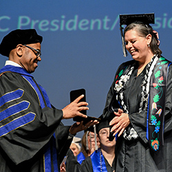 Amber Watson receives the President's Medal from President Faimous Harrison at the graduation ceremony.