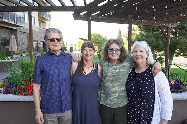 Barbara Oldham stands with three professors at a retirement party.