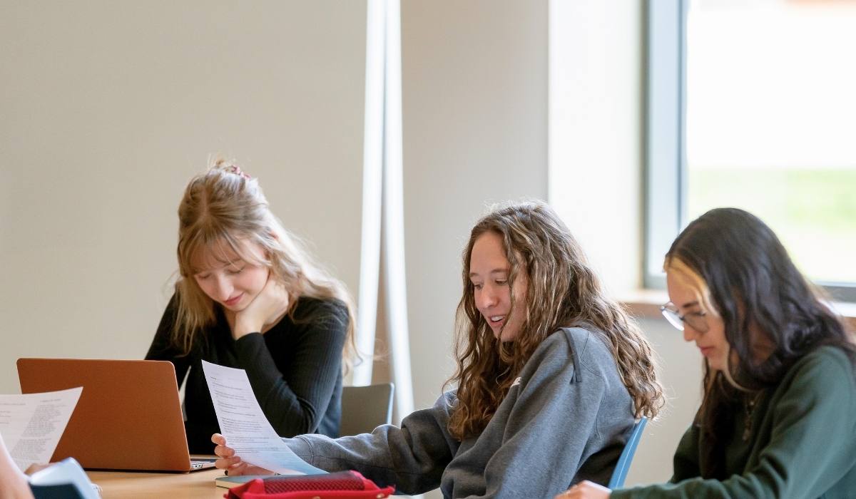 Three students at a table studying