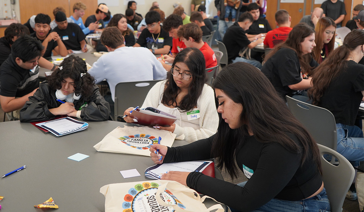 Students in the college's conference center complete paperwork.