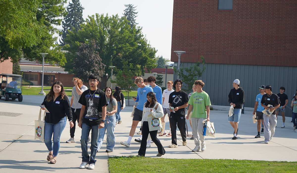 A group of students walk across the Wenatchee campus.